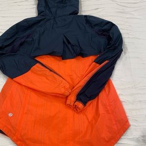 Navy and orange reflective running jacket.